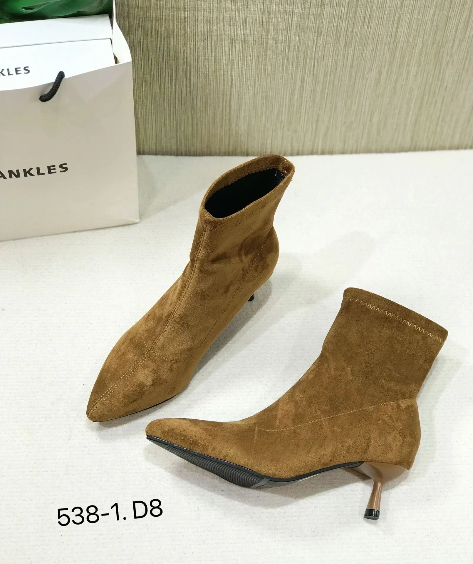 Women's black pointed toe ankle boots with stiletto heel and mid-calf length