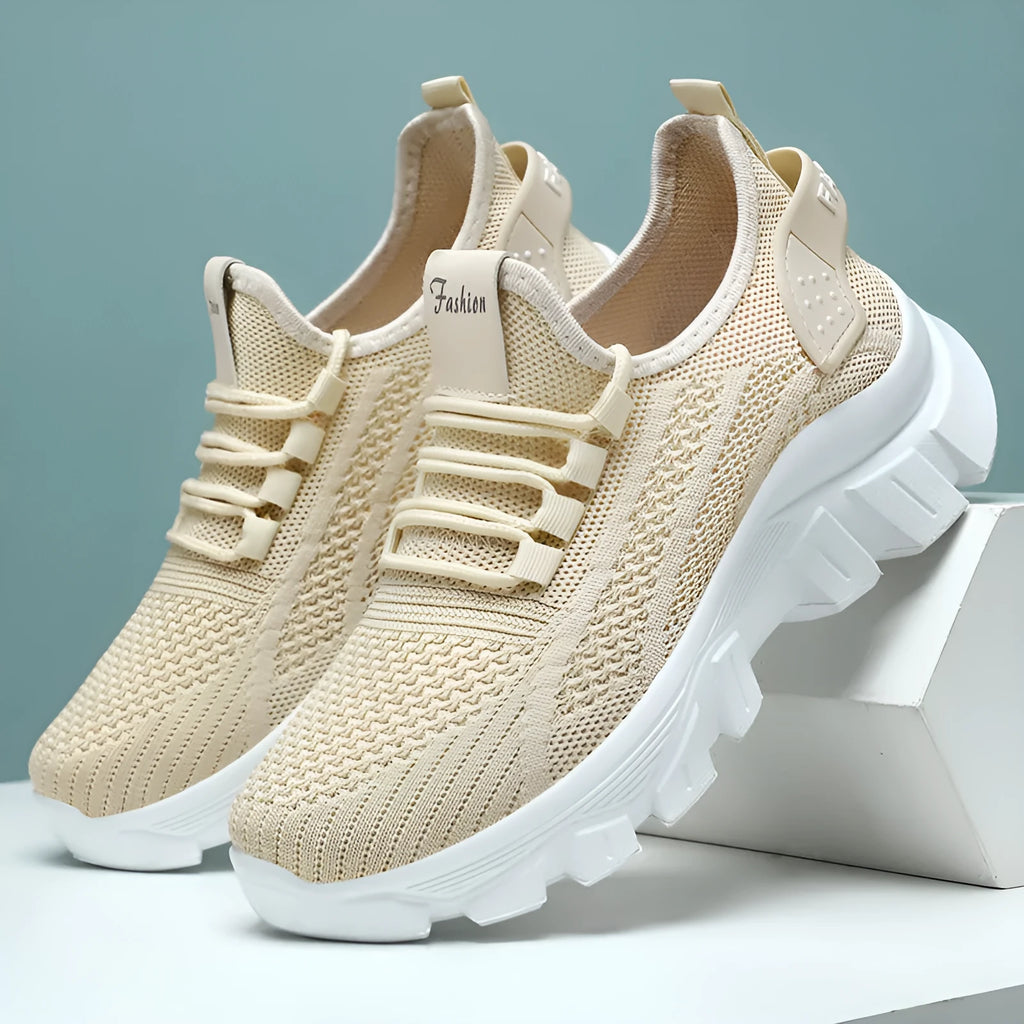 Women's white Flyknit sneaker with thick PVC sole and lace-up closure on a neutral background.