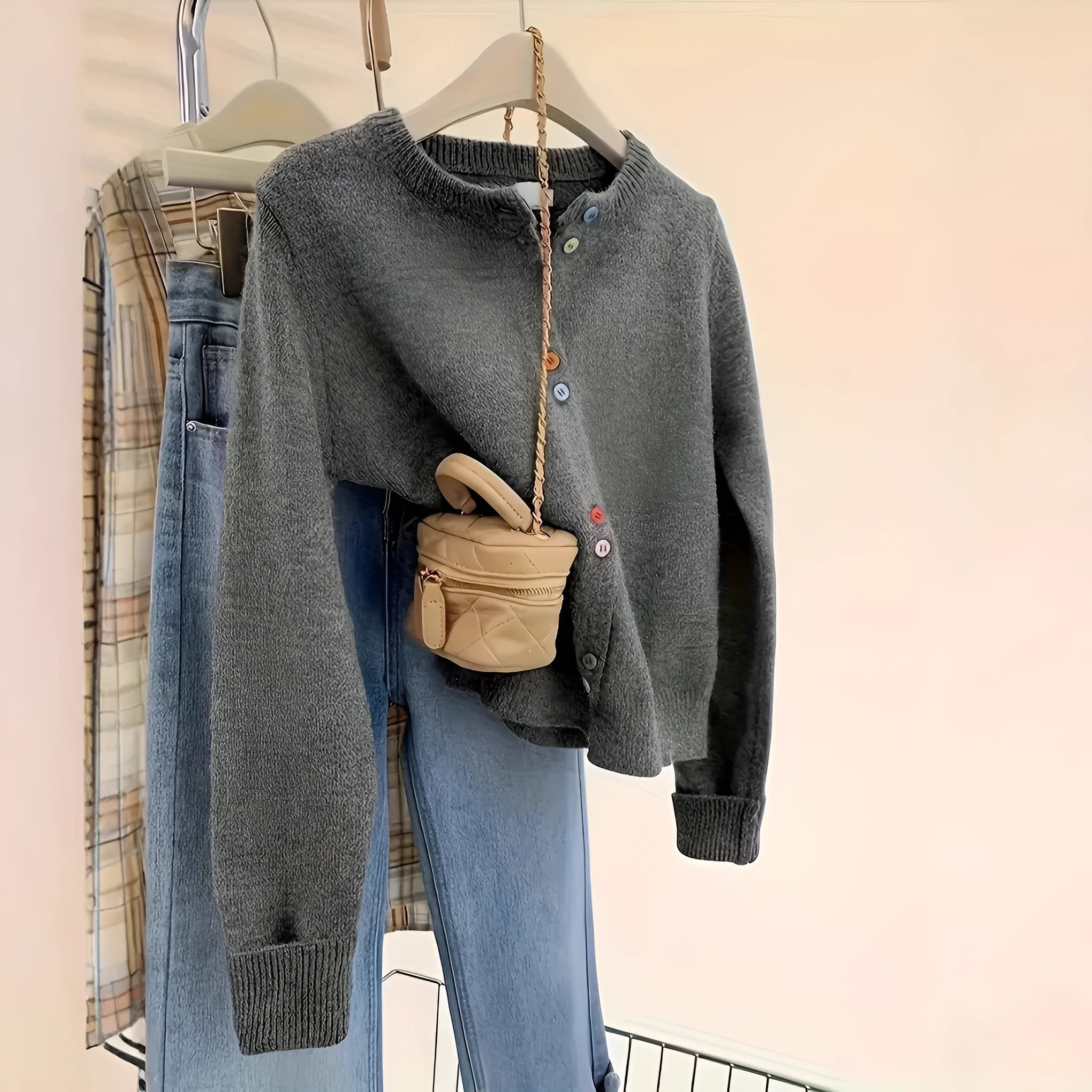 Dark grey solid colour women's cardigan with button front and long sleeves.