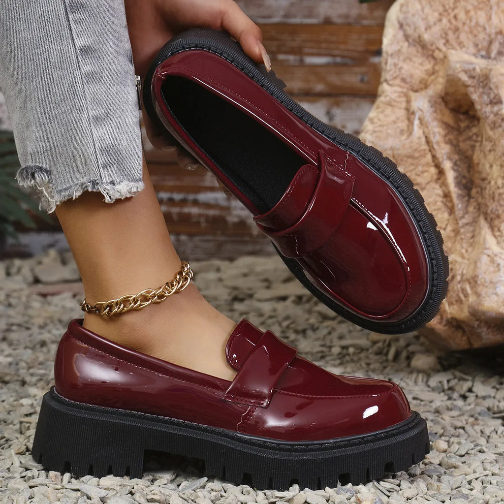 Plus size women's black slip-on loafers with a chunky mid-heel platform and rubber sole