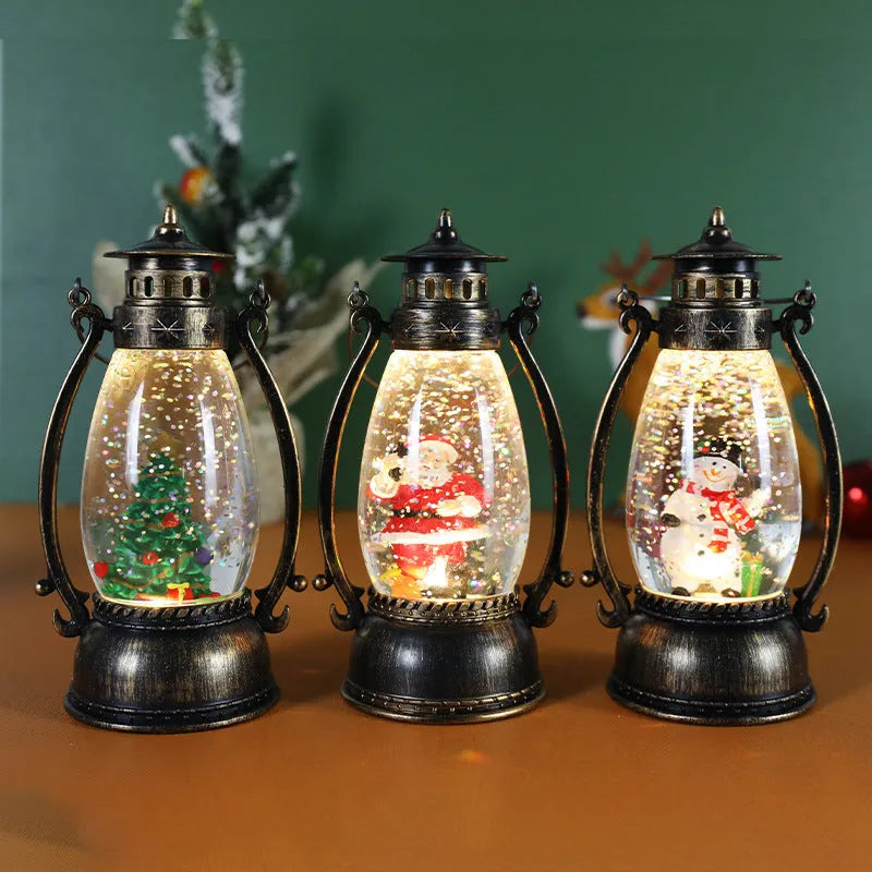 Clear plastic crystal ball oil lamp with LED light, showing snowman and elderly figure design options.