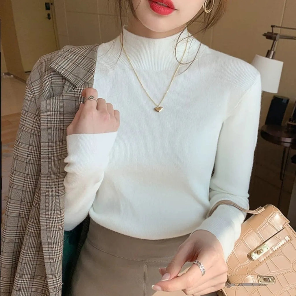 Women's slim fit long sleeve viscose pullover top in apricot colour on a hanger.