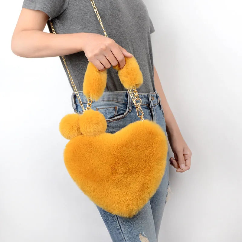 Medium sized soft plush heart-shaped women's handbag in a choice of fourteen colours with a synthetic leather lining