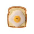 Cartoon patterned latex dog chew toy in egg bread shape with squeaker