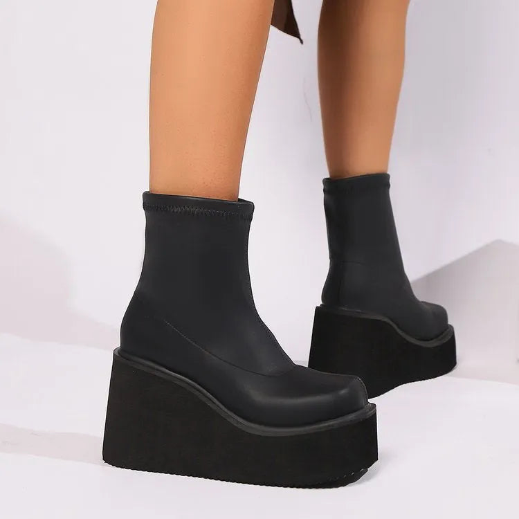 Black plus size women's platform wedge boots with a high shaft and waterproof sole.