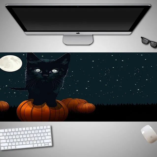 Oversized Halloween pattern mouse pad on a desk showing non-slip rubber base and cloth top.