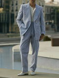 Blue and white striped polyester suit set with blazer and trousers on a hanger