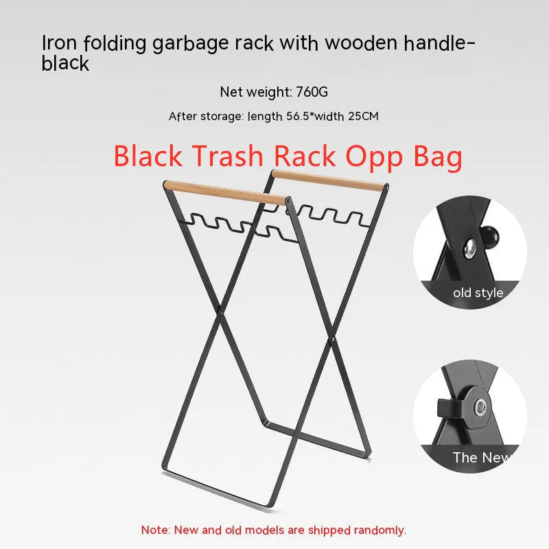 Black outdoor folding iron trash rack with wooden handle holding a rubbish bag.