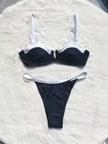 Black low waist women's bikini swimsuit with stitching split detail on a mannequin.