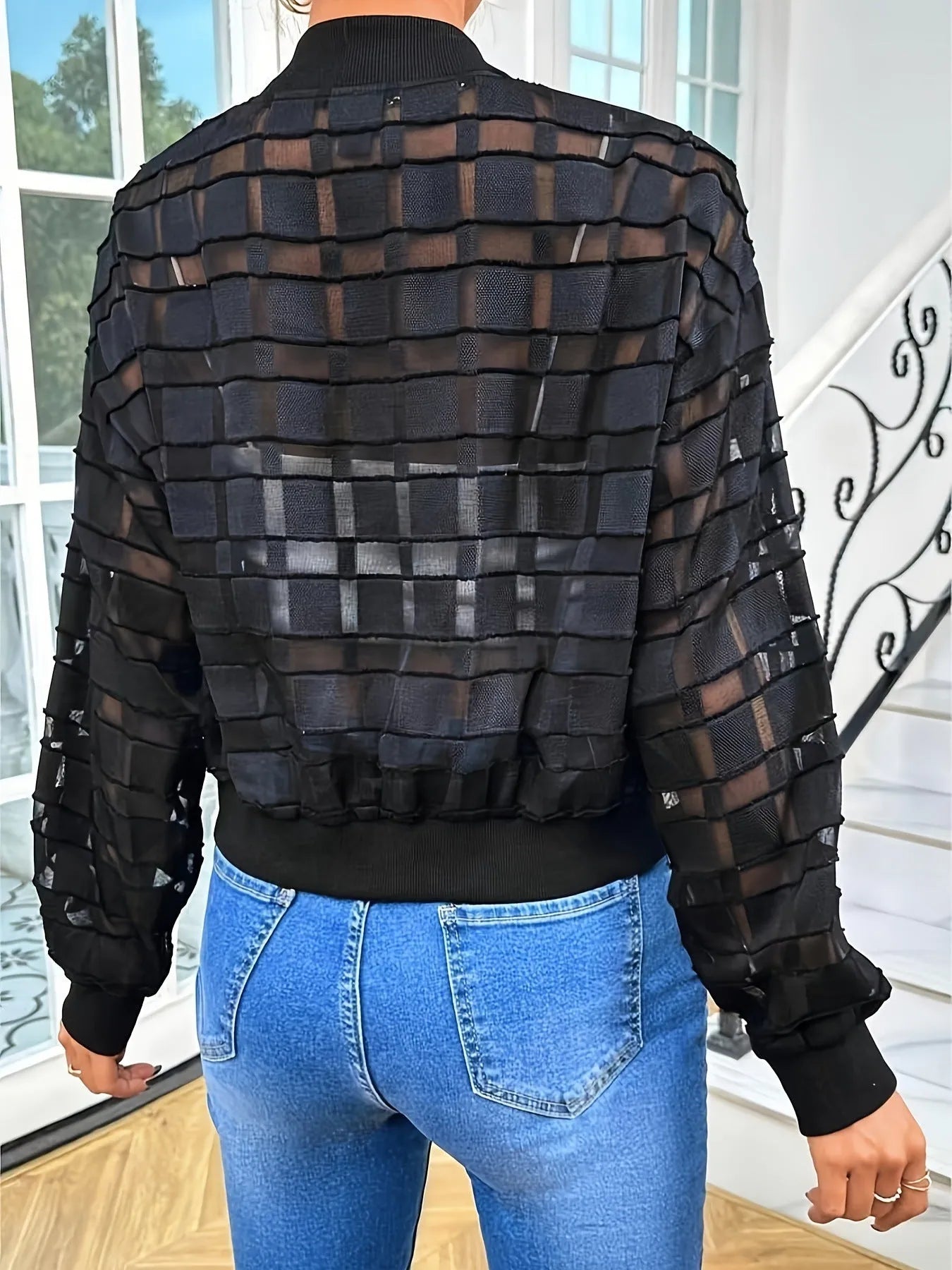 Black women's casual zip jacket with a semi-transparent geometric pattern.