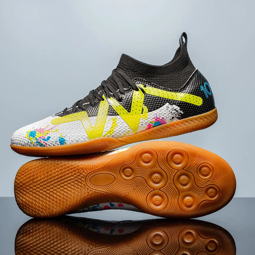 Low-top soccer shoes in black and yellow colour with a PVC upper and rubber studded outsole.