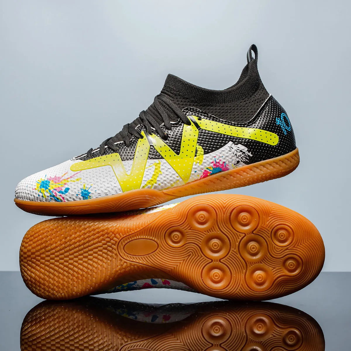 Low-top soccer shoes in black and yellow colour with a PVC upper and rubber studded outsole.