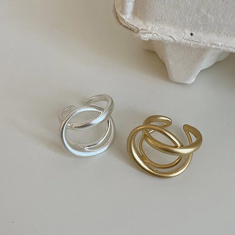 Geometric open ring with three-dimensional interlaced matte metal design and gold electroplating