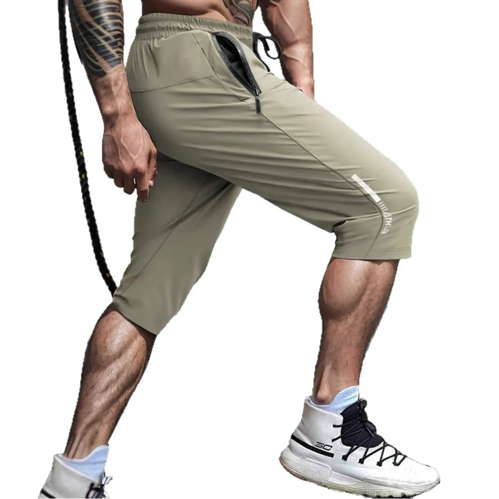 Man wearing gray ice silk nylon cropped sports casual pants with a straight leg.
