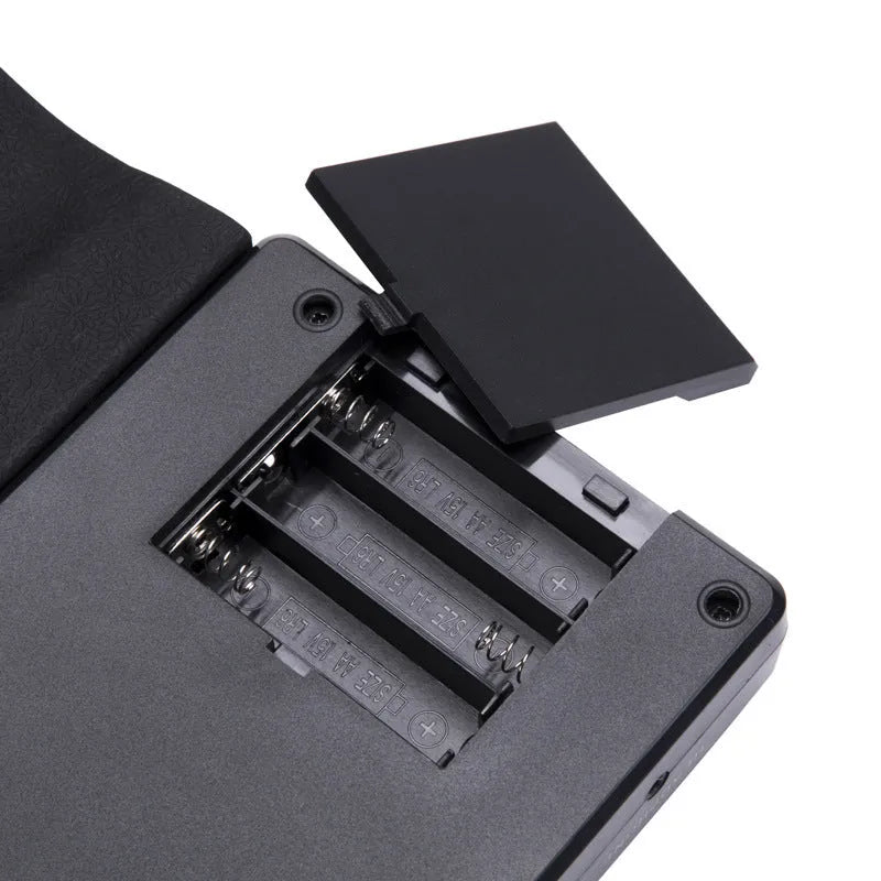 49 key portable folding electronic keyboard in gloss black colour showing compact folded size and included accessories