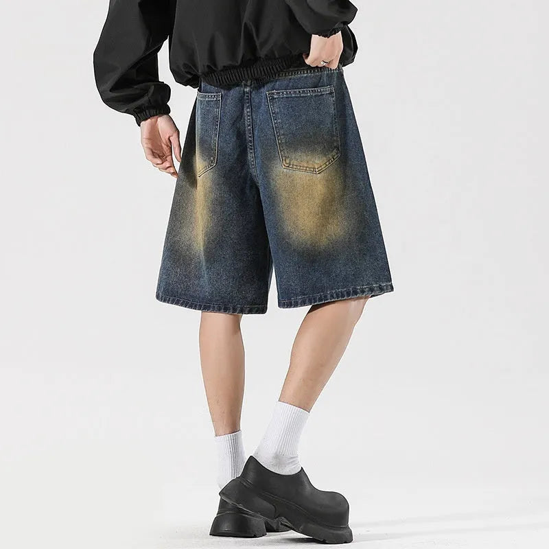 Man's loose-fit ripped jeans in retro blue denim, showing distressed detailing on legs.