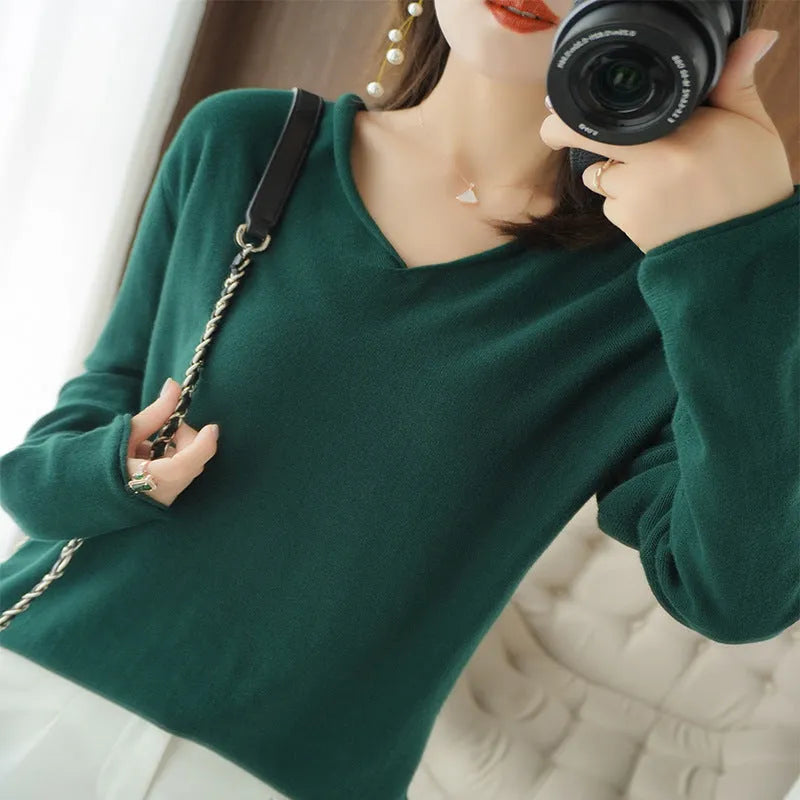 Women's turmeric V-neck long sleeve knitwear top laid flat.