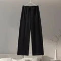 Women's black polar fleece long sleeve pleated top and wide leg trousers suit set.