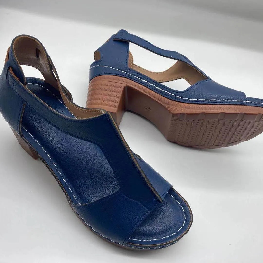 Plus size beige wedge sandals with peep toe, open sides, and a Roman-style ankle buckle.