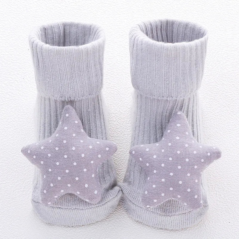 Cotton baby floor socks in a selection of colours and patterns like panda, lion, and bows, shown in sizes for infants.