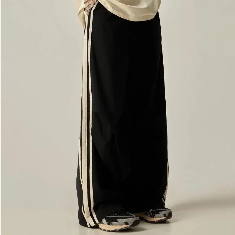 Black wide leg climbing trousers with high waist and straight leg design on hanger