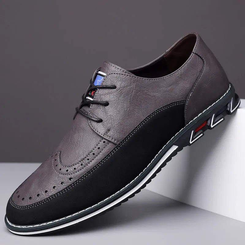 Men's black casual slip-on shoe with leather toe cap and decorative stitching on fabric upper.