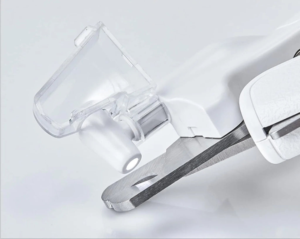 White pet nail clipper with LED light on handle and transparent anti-splash guard surrounding the blades.