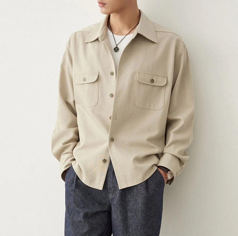 Men's light sand rice coloured long sleeve shirt with a lapel collar, laid flat.