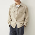 Men's light sand rice coloured long sleeve shirt with a lapel collar, laid flat.