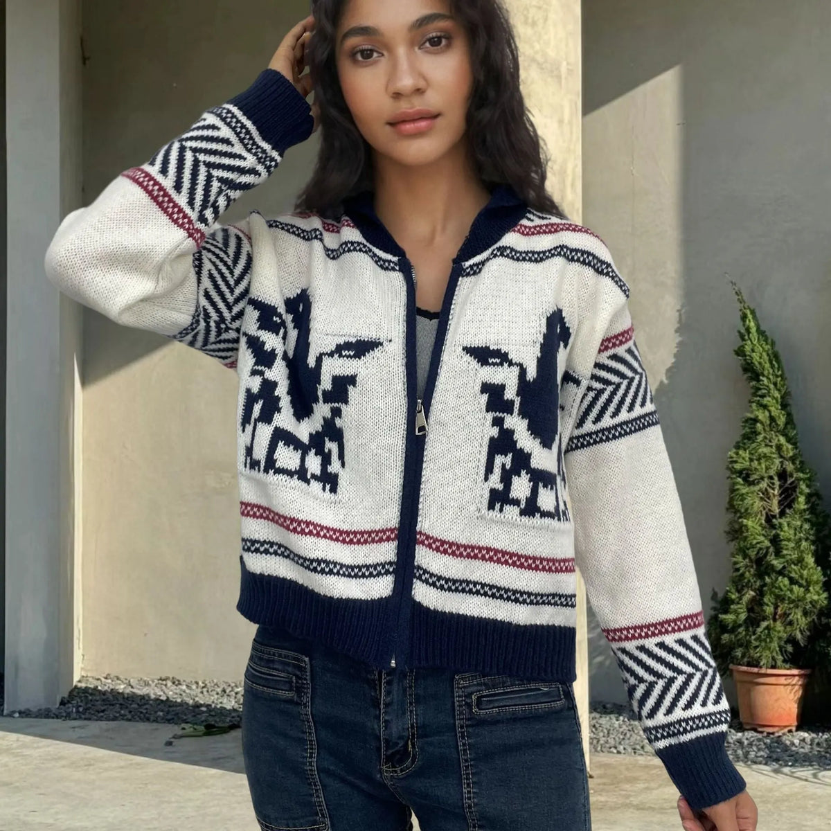 White women's cardigan sweater with a front zipper, lapel collar, and a vertical jacquard contrast stripe.