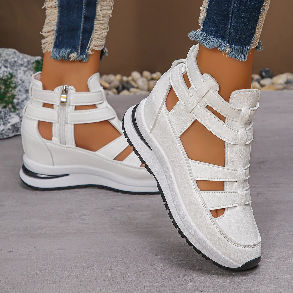Women's black close-toed hollow-out platform sandals with Velcro strap on a white background.