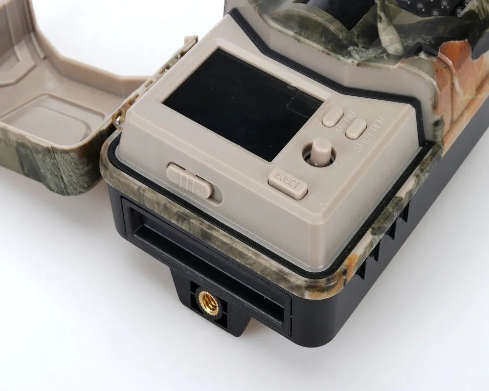 Outdoor hunting camera with camouflage finish showing LCD screen and infrared LED array