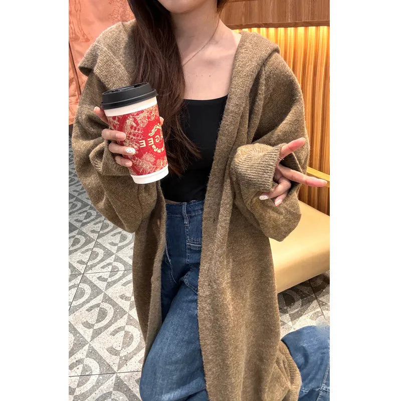 Women's long brown knitted hooded cardigan with a loose fit and below-the-knee length.