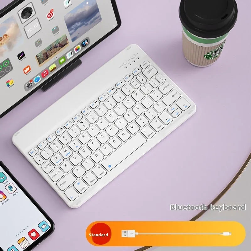 Compact white Bluetooth keyboard for tablet and PC use on a wooden desk