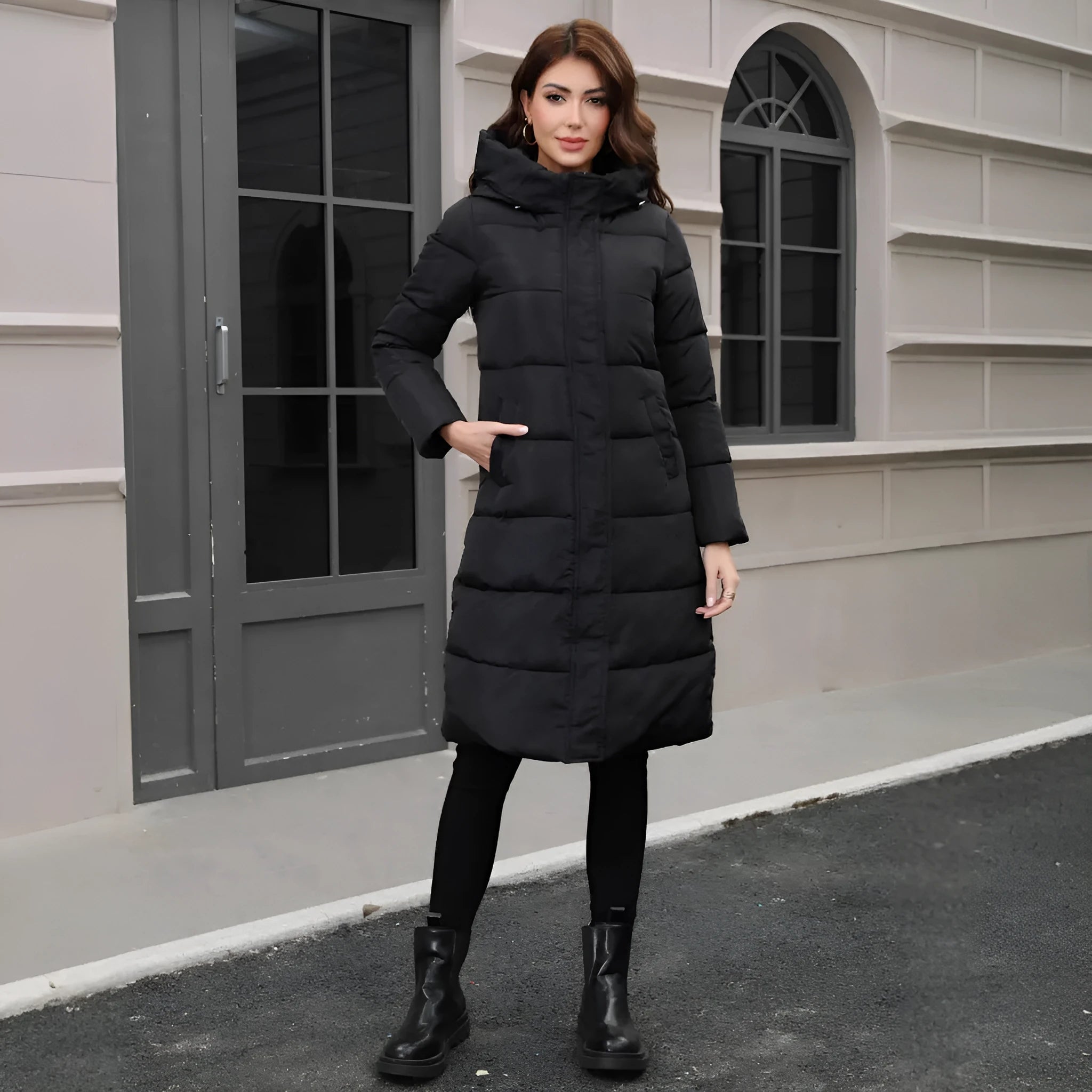 Black slim fit hooded jacket with long sleeves on a hanger.