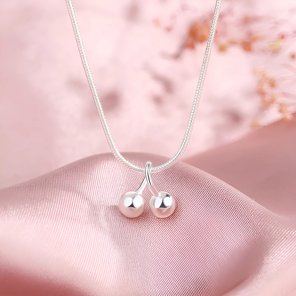 Silver cherry pendant necklace on a snake bone chain, adjustable from 21cm to 50cm.