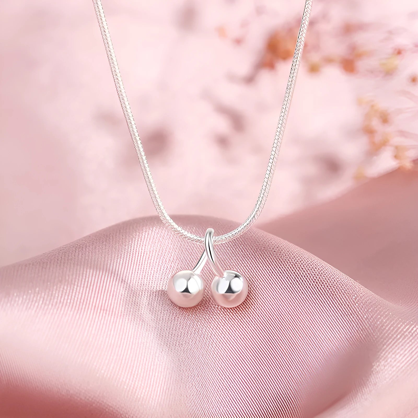 Silver cherry pendant necklace on a snake bone chain, adjustable from 21cm to 50cm.