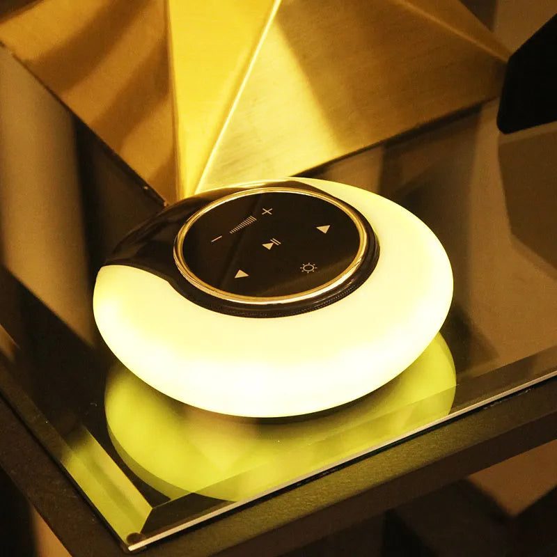 Blue Bluetooth speaker desk lamp with folding design and touch controls showing white, yellow and blue LED lighting