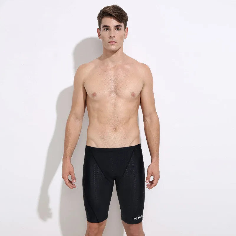 Men's black swimming set with briefs trunks, anti-fog goggles, waterproof cap, ear plugs, nose clip, and carry bag.