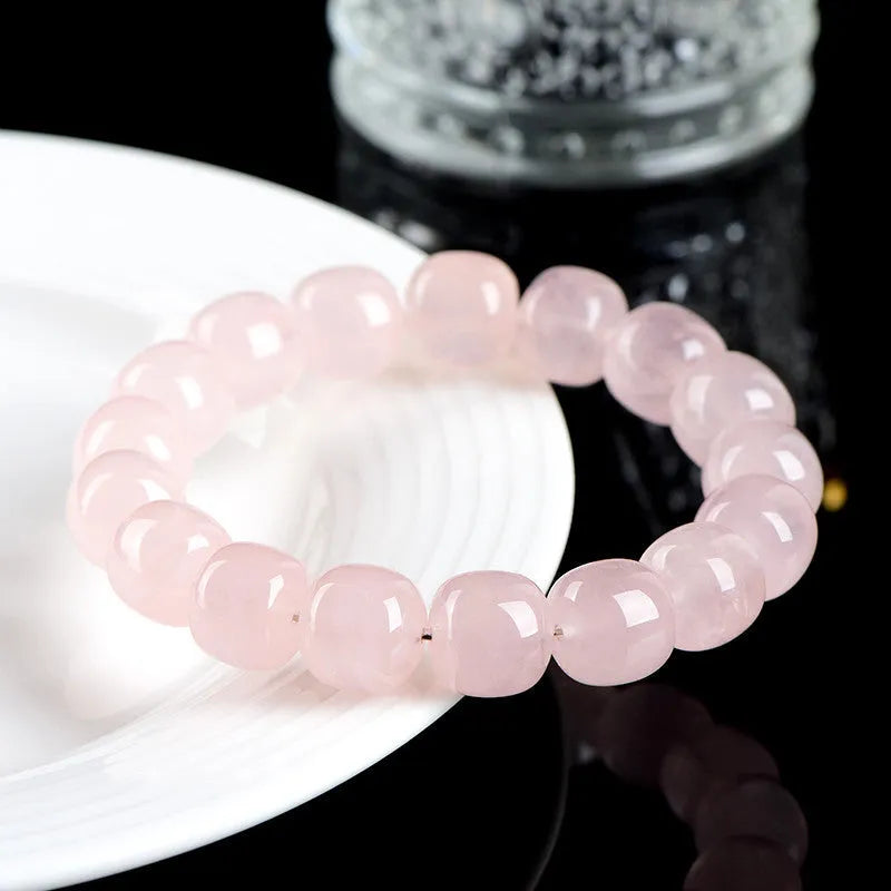 Pink bamboo crystal barrel bead bracelet with geometric design on wrist
