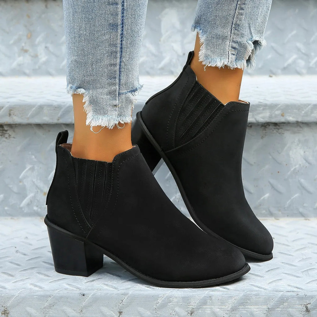 Women's black pointed toe ankle boots with thick square heel slip-on design