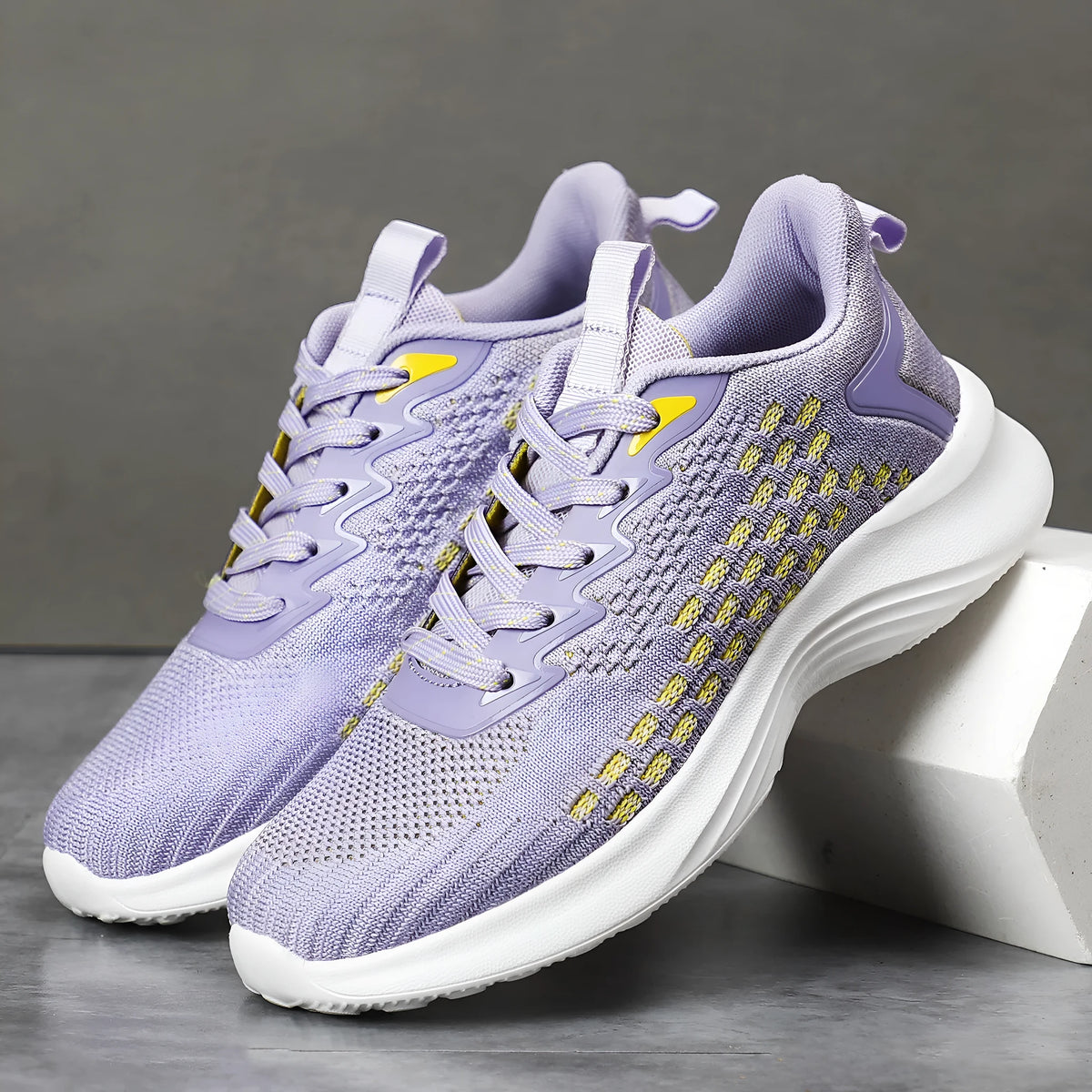 Women's lavender purple Flyknit running shoes with mesh lining and EVA sole, shown in a side view.