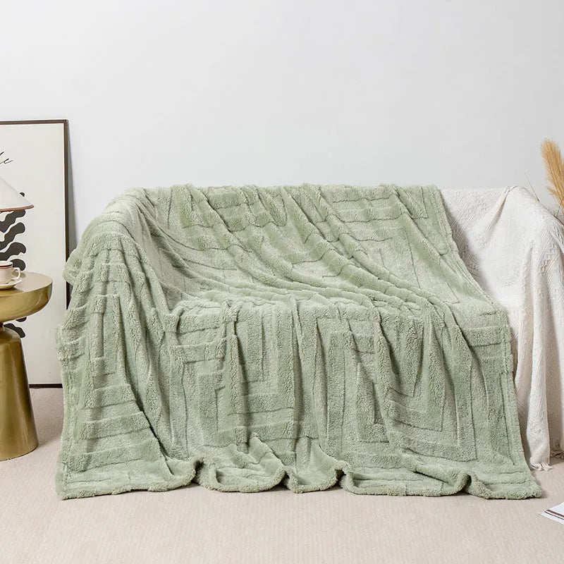 Thick coral fleece flannel sofa blanket in a solid colour, laid flat showing its texture.
