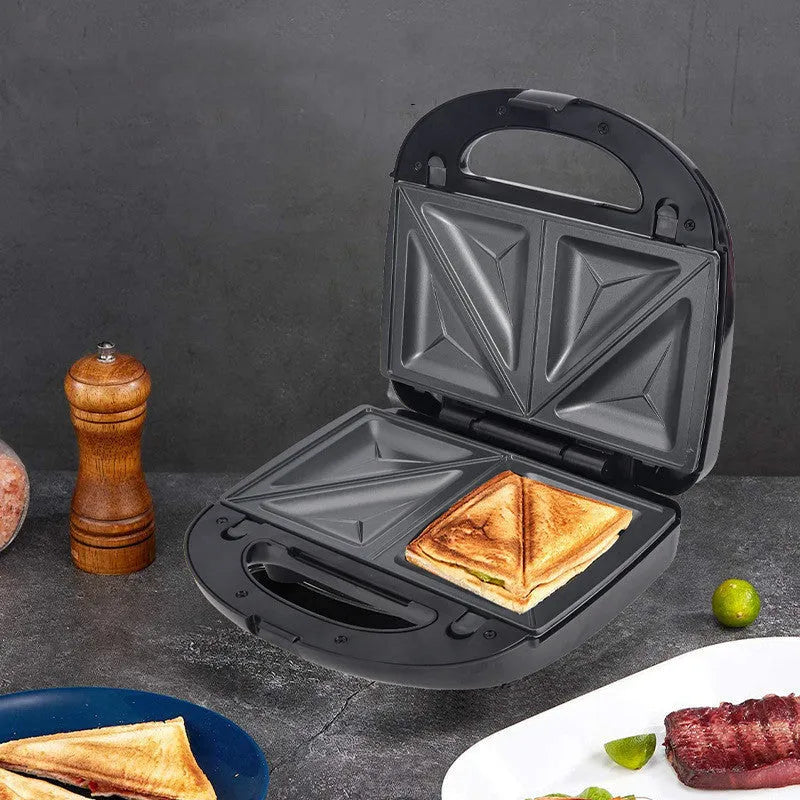 Black electric sandwich pan with double-sided heating, brushed stainless steel lid, and non-stick cooking plates.