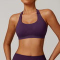 Women's black halter neck yoga sports bra with a removable padded insert.