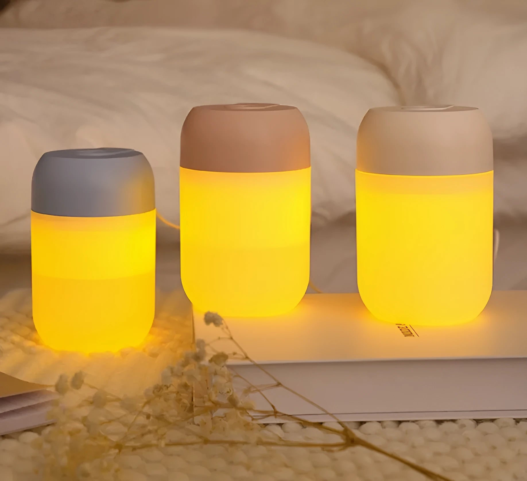 White cylindrical mini humidifier with USB cable on a desk