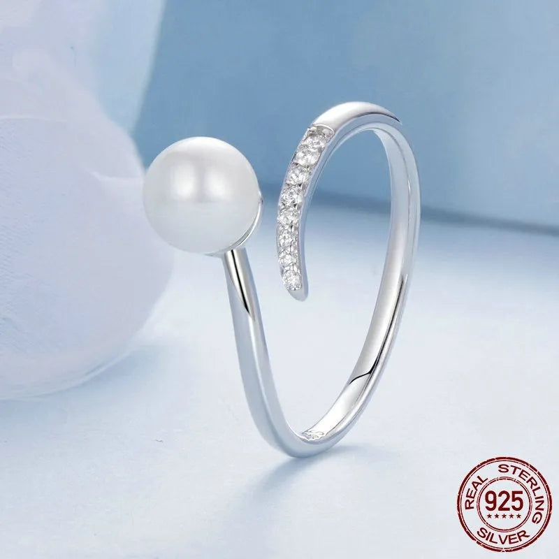 Adjustable S925 sterling silver ring with natural shell pearl elements and open loop design