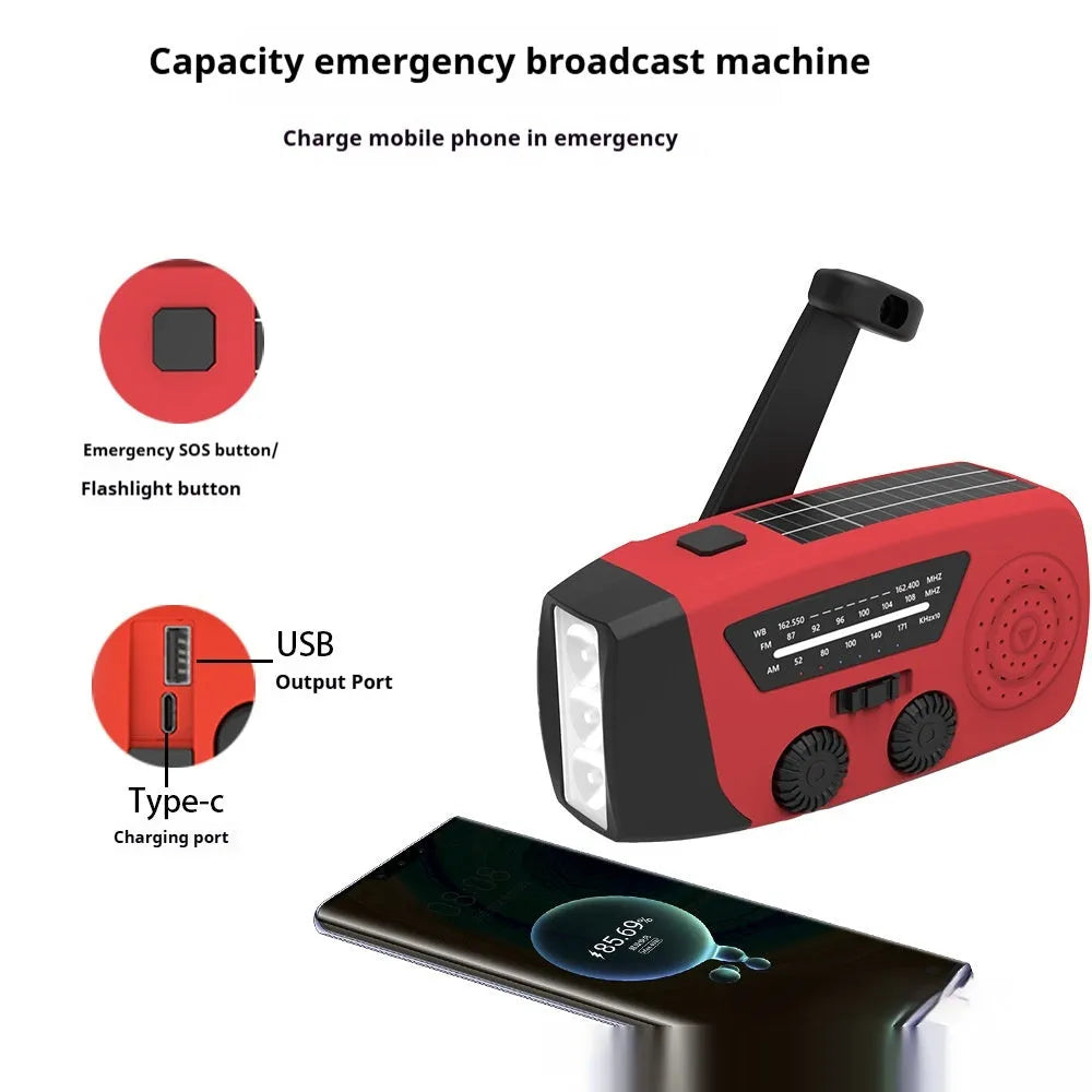 Red rechargeable emergency hand radio with built-in torch, showing compact size and wrist strap.