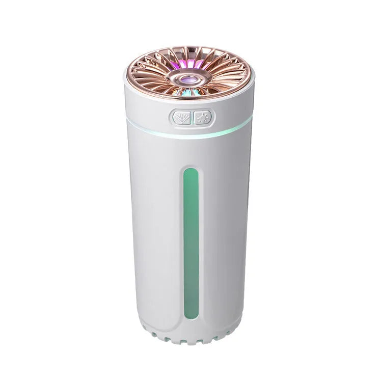 Black wireless ultrasonic humidifier with colourful lights, shown next to a USB cable on a desk.