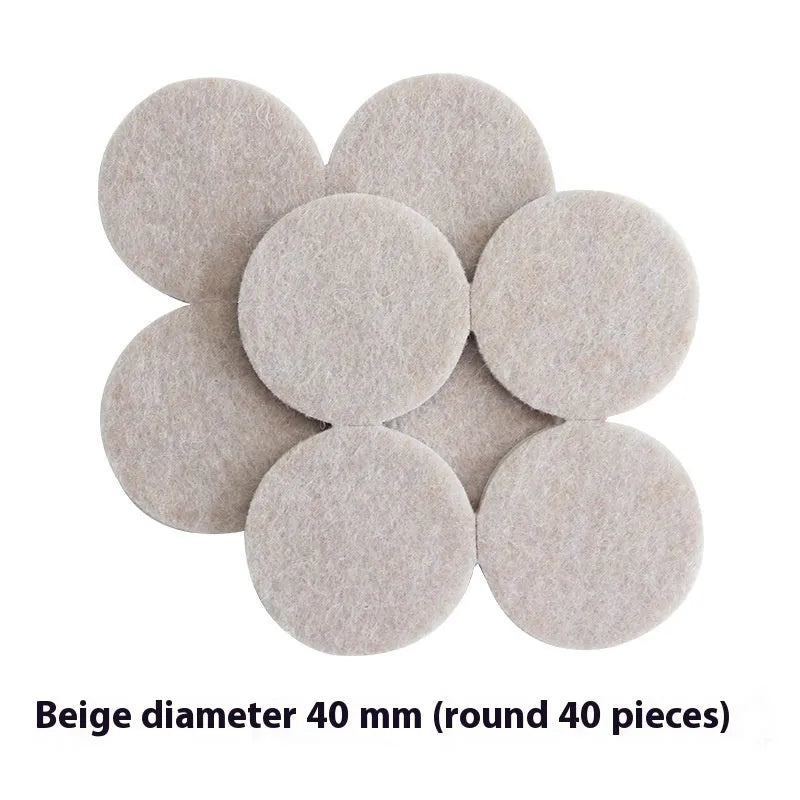 Beige plastic furniture leg stopper pads in five different sizes on a wooden floor